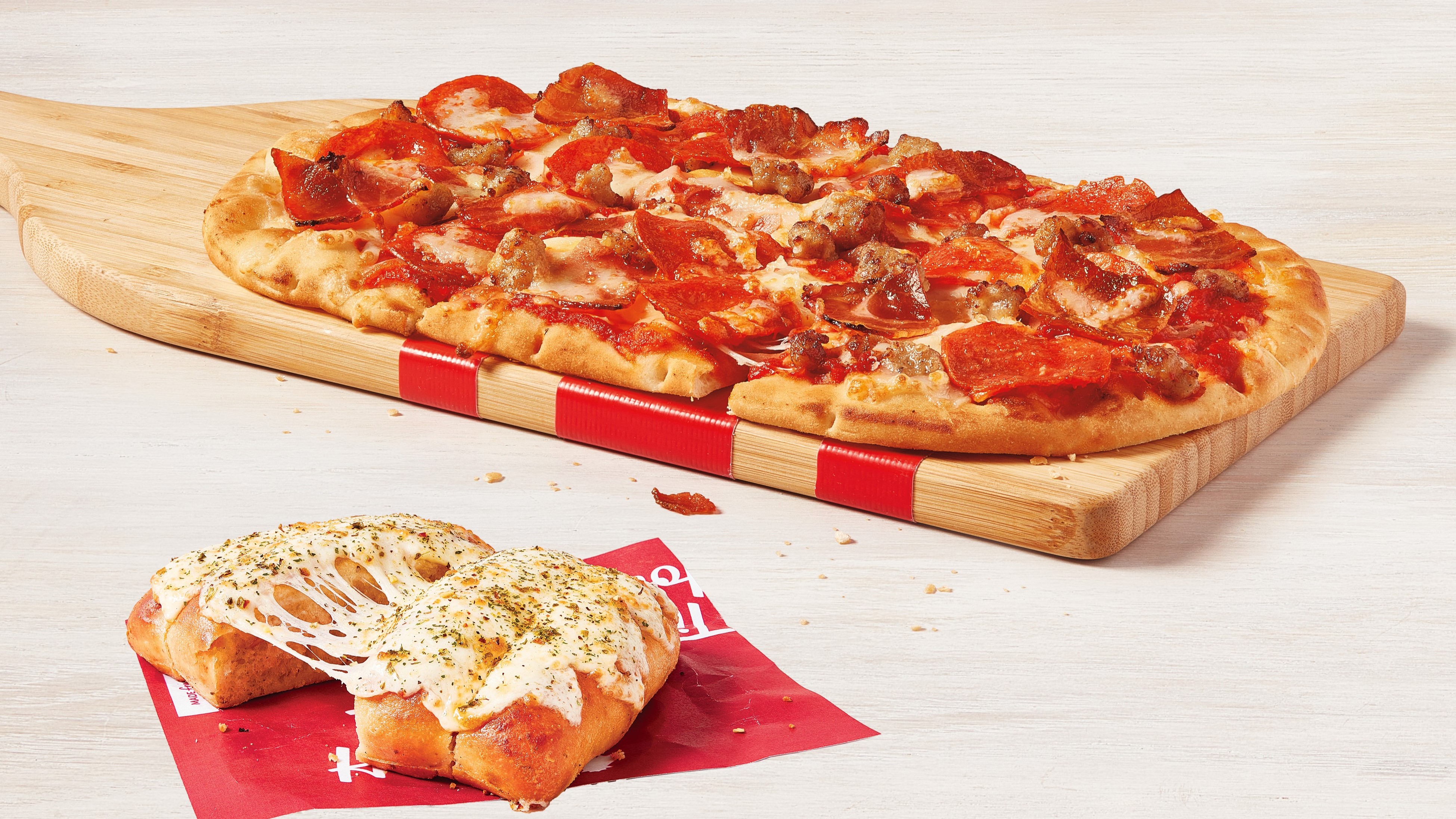 Canadians score with NEW Tim Hortons 3 Meat Hat-Trick Flatbread Pizza and Tims Garlic Bread, a deliciously cheesy side item to add to any lunch or dinner
